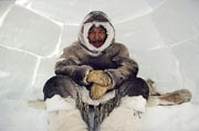 Thomasie Nutarariaq, an Inuk from Igloolik sitting inside an Igloo. Nunavut, Canada. 1990