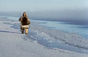 Louis Tepardjuk, dressed in caribou skin clothing, while hunting at the floe edge. Igloolik, Nunavut, Canada.