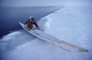 Inuit hunter,Avataq Henson, uses a kayak at the ice edge in winter. NW Greenland.