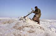 Tyhyko Yar, a Nenets man makes an offering at the sacred site of Huunghor-Sala. Gydan Peninsula, W.Siberia, Russia