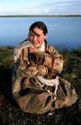 Alla, A Nenets girl, poses with her pet cygnet at a summer camp near Nadym, Yamal, W.Siberia, Russia